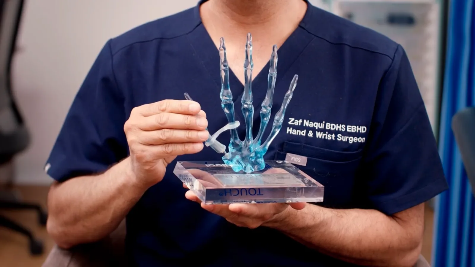 Mr Zaf Naqui demonstrating the TOUCH thumb implant on an anatomical hand model